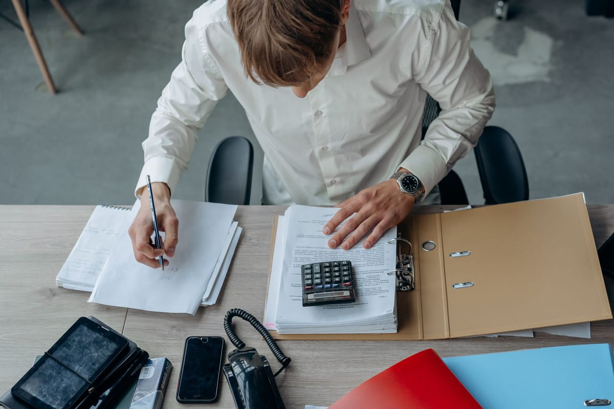Working through a ledger with a calculator
