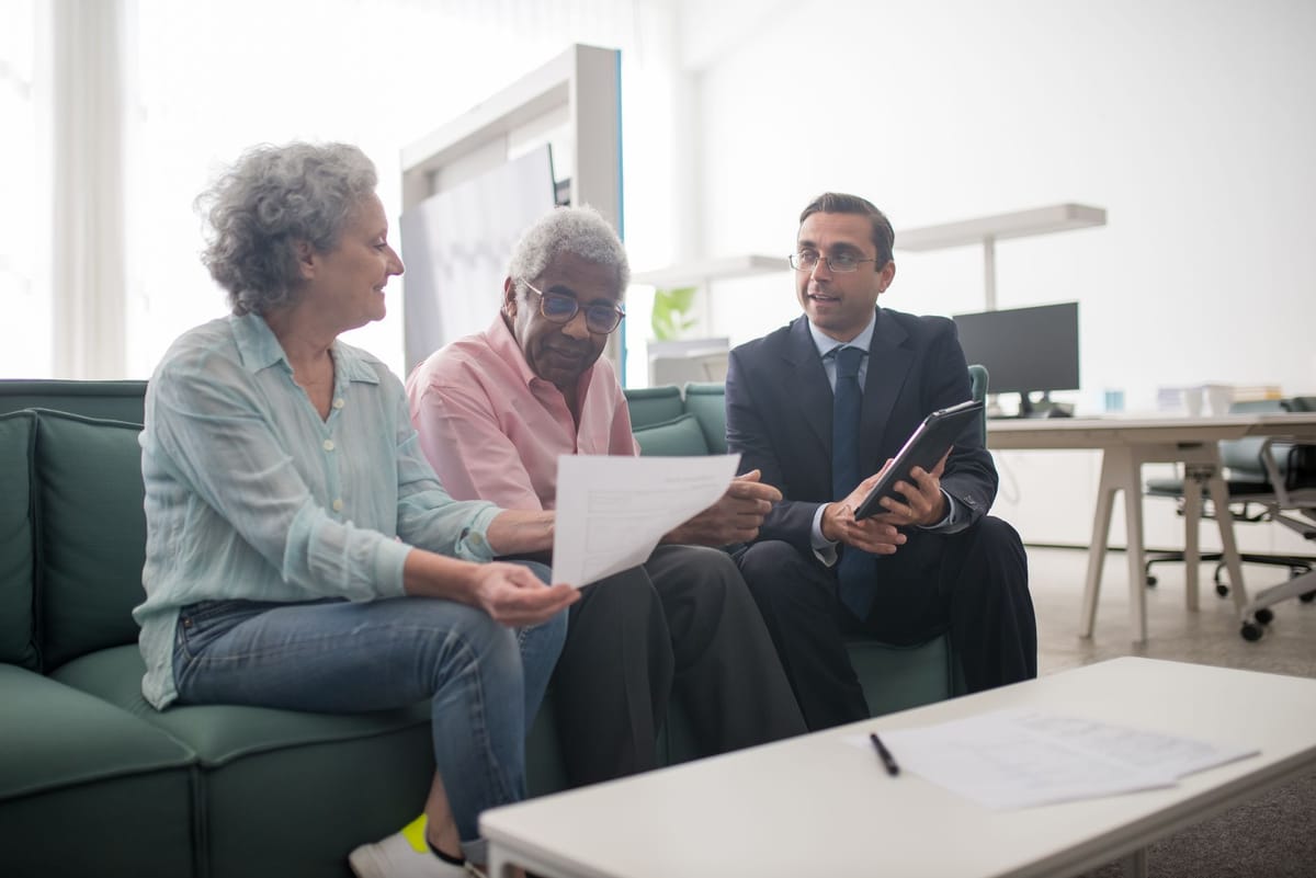 A couple reviewing a plan with their advisor