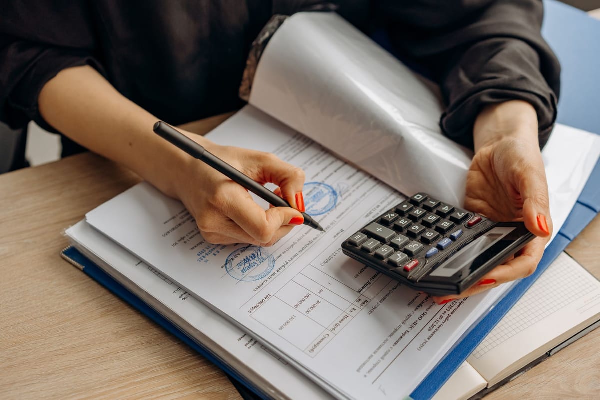 Checking figures on a tax form with a calculator